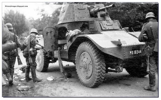German soldiers examine a captured French armored car, Panhard 178. May-June 1940