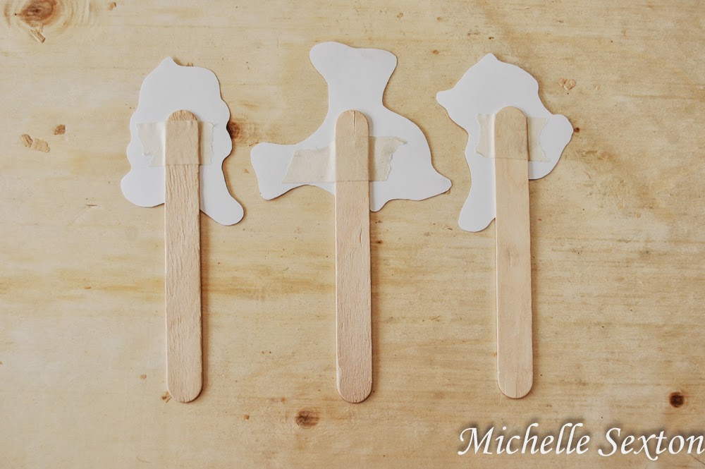 tape puppets to popsicle sticks