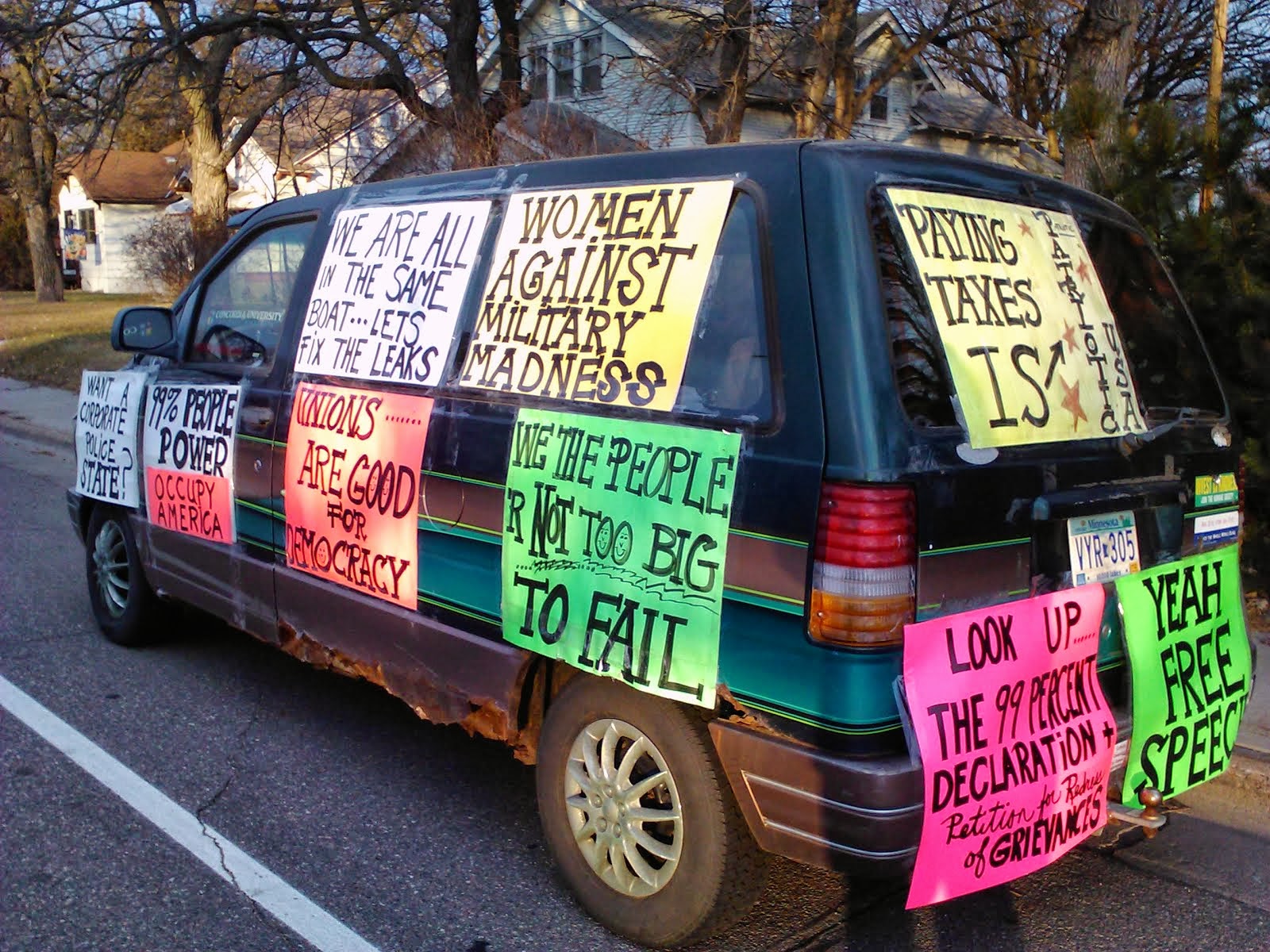 van decked out with signs after told to remove from yard