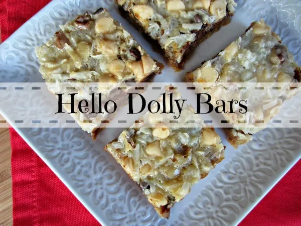 Hello Dolly bars (4) cut on a white plate ready to eat