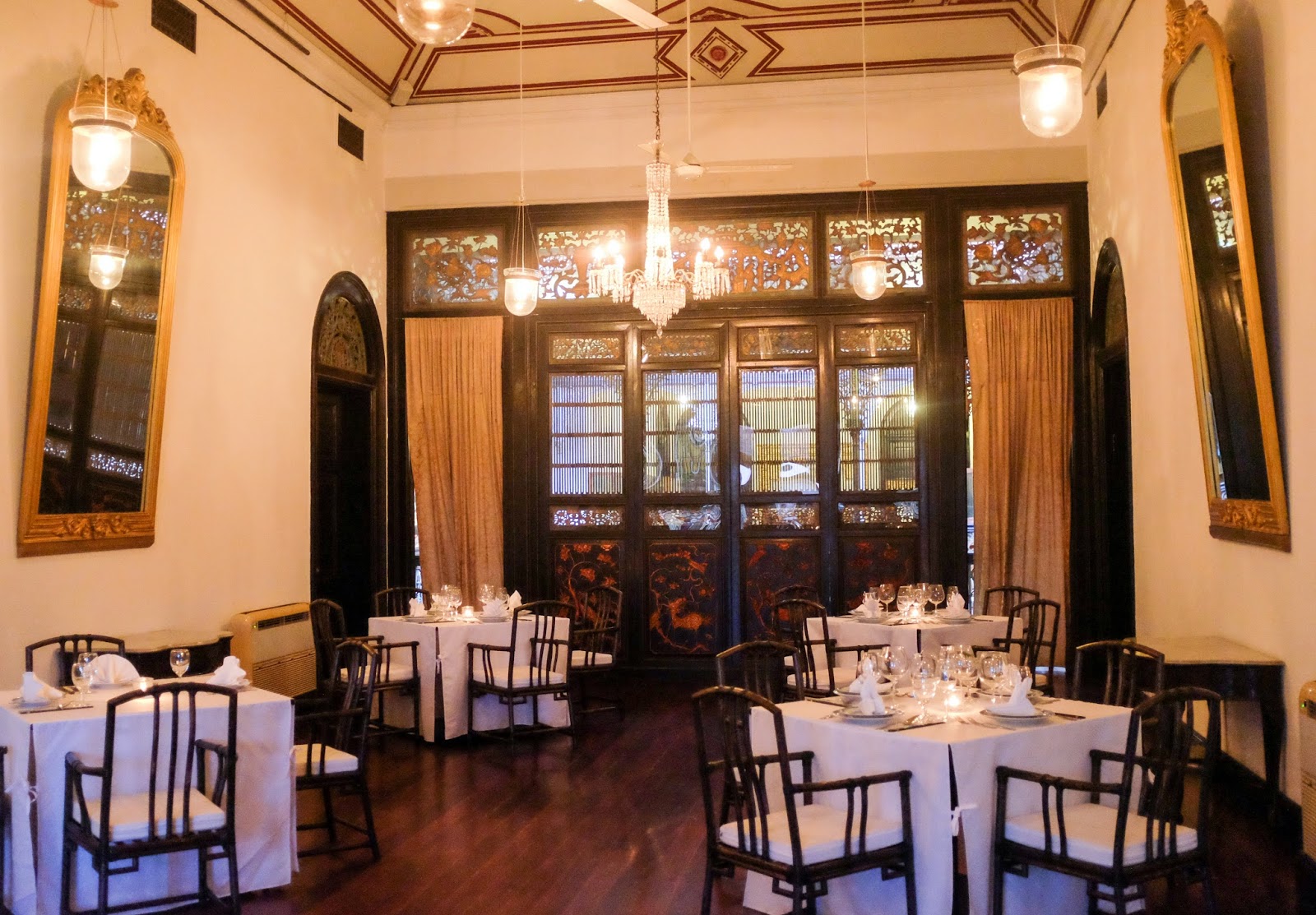 this much respected restaurant serves modern cantonese cuisine in the blue mansion a penang boutique hotel with an indigo blue facade and a lavish interior