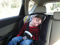 Toddler asleep in the back car seat