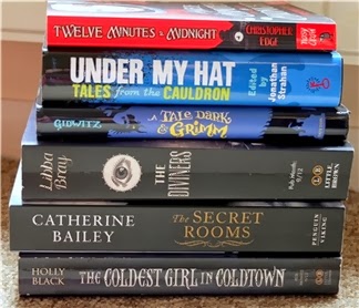 Book pile containing the titles listed below