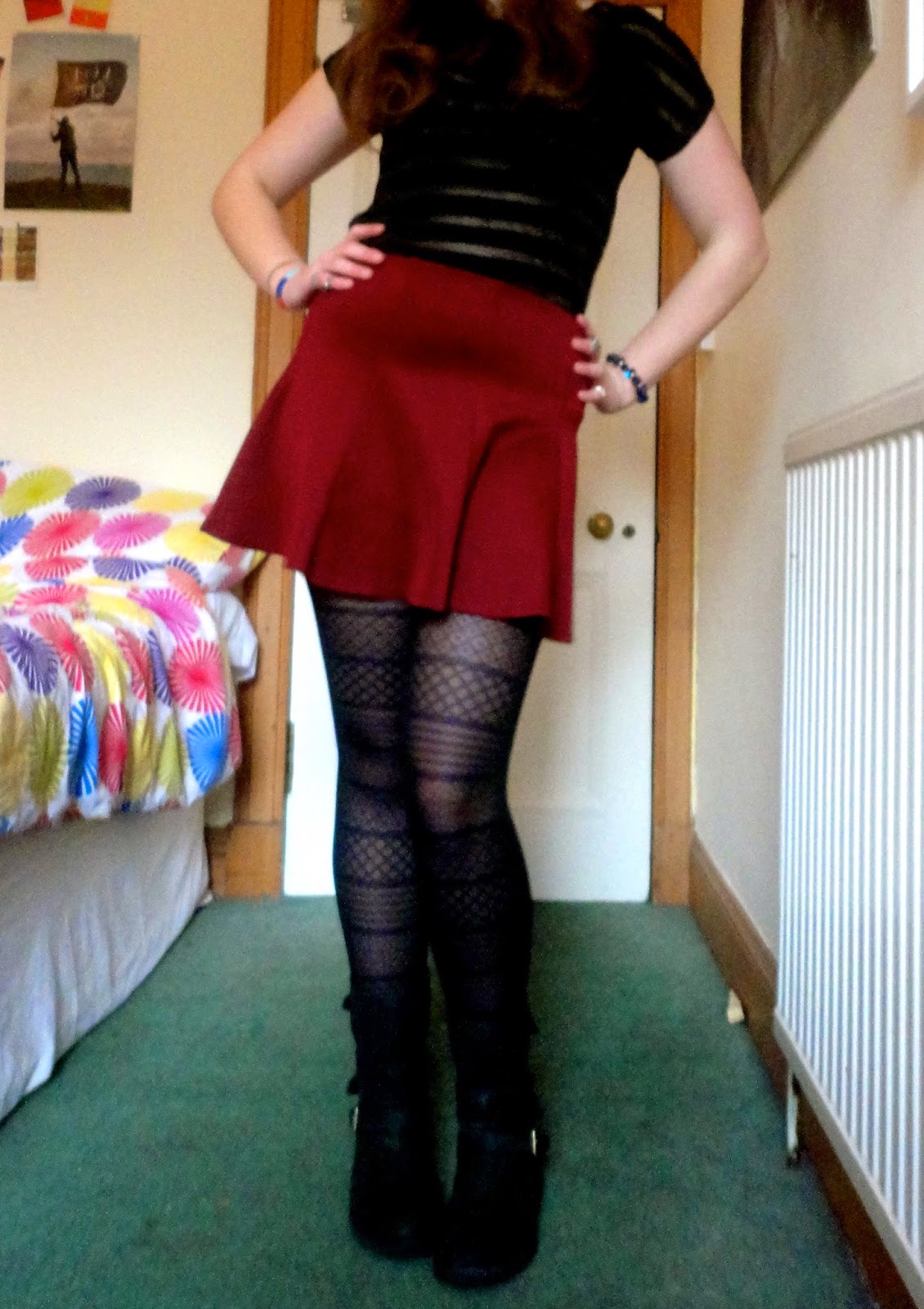 Outfit of black striped top, red skirt, patterned tights and black boots