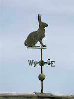 a-rabbit-shaped-weather-vane-atop-a-roof.jpg