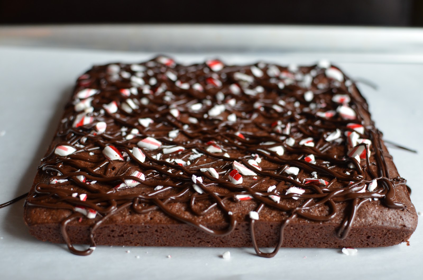 Playing with Flour Peppermint brownies topped with candy cane and dark