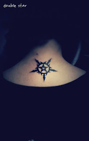 a small star inside of a bigger star tattoo