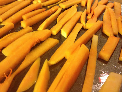 butternut squash fries on a greased baking tray