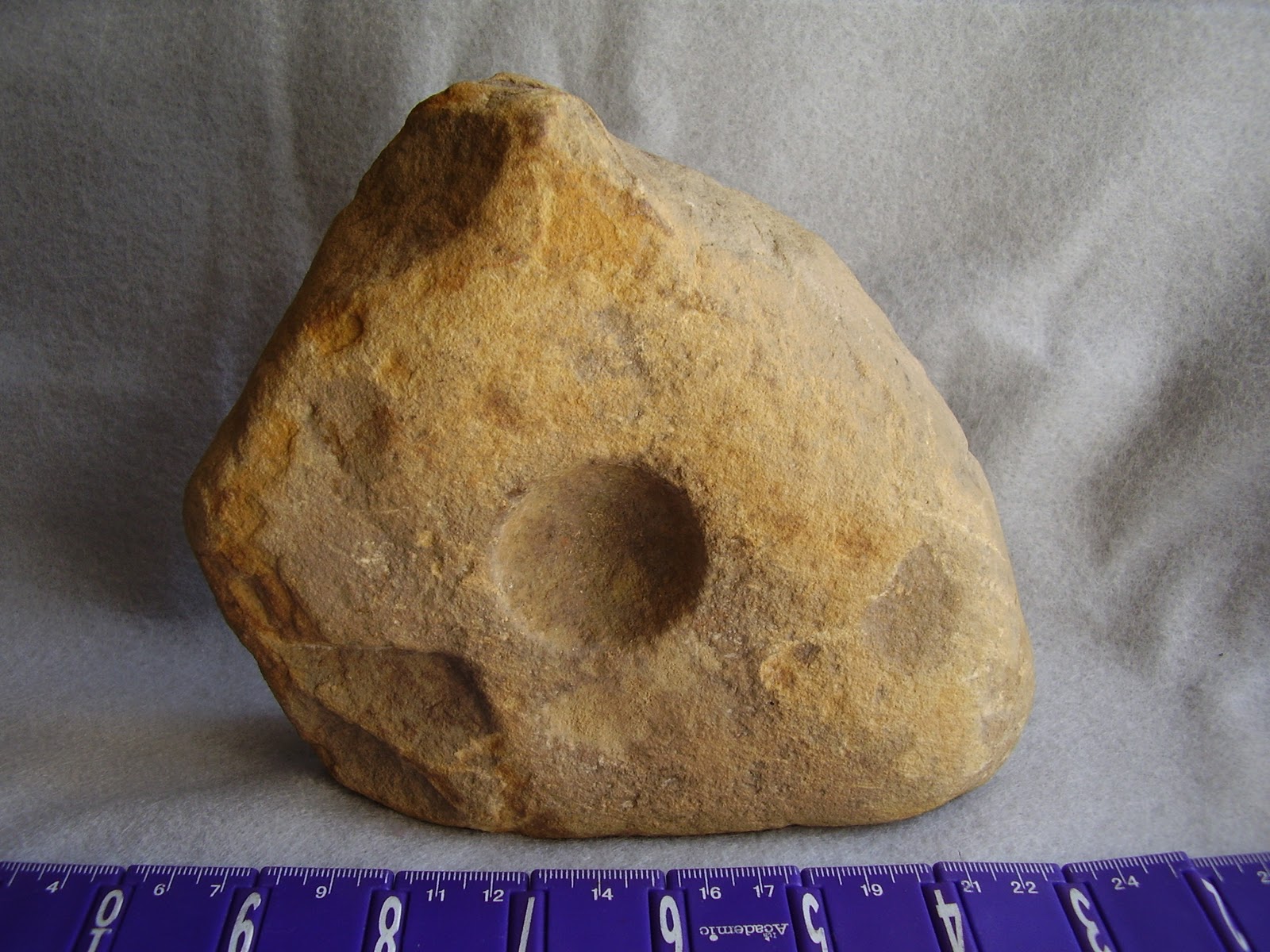 Archaeology of Portable Rock Art Rocks' pits may be art "cupules" on