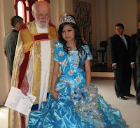 Dalia and her priest, Fr. Don Maddux of La Iglesia de San Juan in Olympia, share a moment. Some of her chambalanes are in the background. Dalia Martinez and her priest