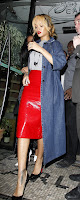 Rihanna weariong a red skirt