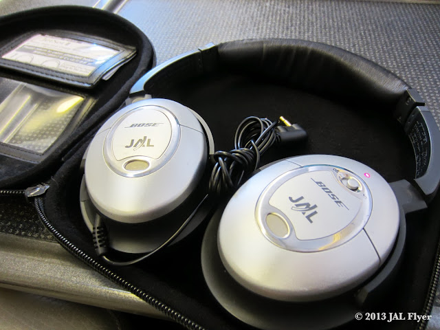 JAL First Class - Customized Bose QuitComfort 2 headphones with JAL logos on them.