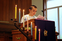 a youth reads scripture from the pulpit at youth-led worship