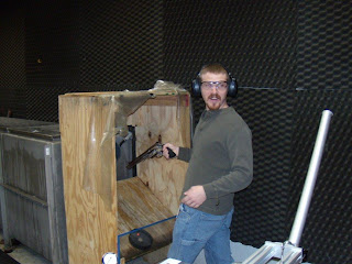 Firearms Examiner Kevin Callahan prepares to fire a large caliber revolver in a water tank during training.