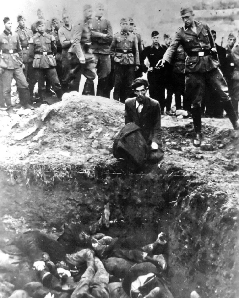 The last Jew in Vinnitsa  Member of Einsatzgruppe D (a Nazi SS death squad) is just about to shoot a Jewish man kneeling before a filled mass grave in Vinnitsa, Ukraine, in 1941. All 28,000 Jews from Vinnitsa and its surrounding areas were massacred.