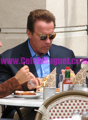 Arnold Schwarzenegger eating lunch with friends