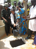 US Ambassador to Senegal Marcia S. Bernicat and Tostan Supervisor Aïssatou Kébé pull out the first bucket of water from the new well at Hann youth prison. The well will provide detainees with water for washing and benefit the agricultural training program initiated by Tostan.