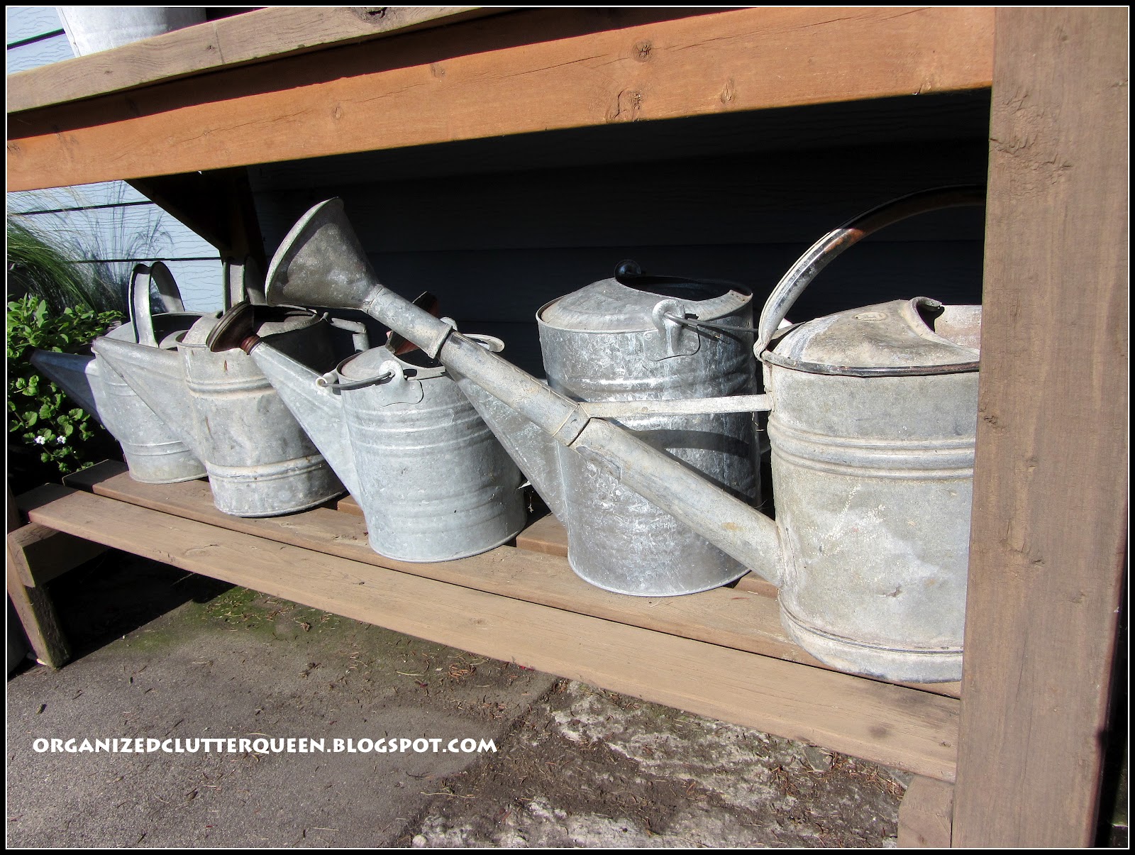 Potting Bench, Whiskey Barrels, and Hanging Pails Organized Clutter