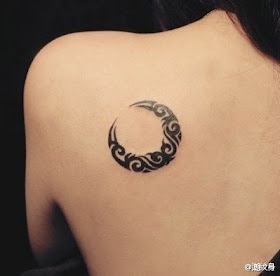 a crescent moon shape totem tattoo