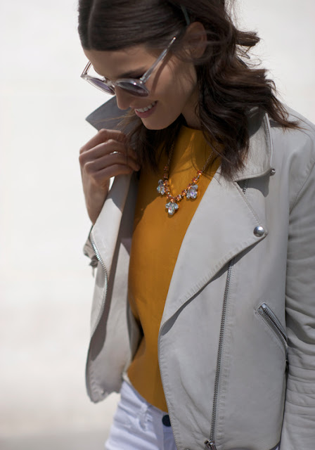 Hanneli Mustaparta in a leather jacket yellow top