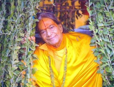 Shree Maharajji pictured next to a tree