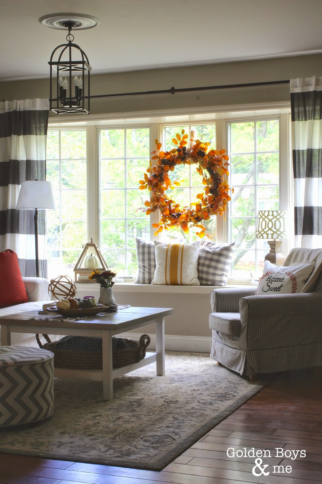 Fall decor in living room with Ikea hack plank coffee table and striped drapes-www.goldenboysandme.com
