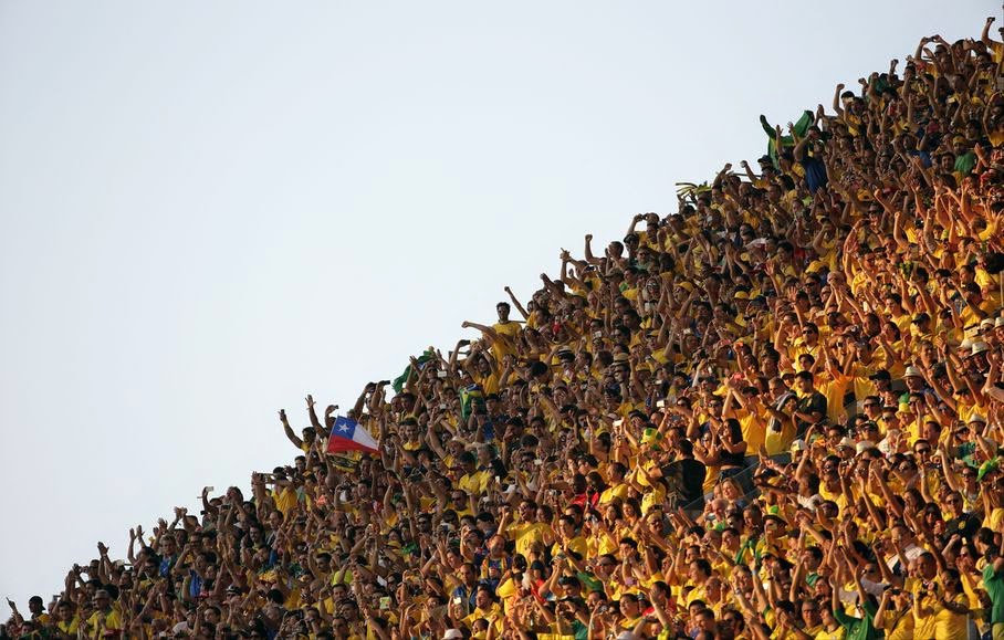 Fans cheer before the group A World Cup soccer match between Brazil and Croatia, the opening game of the tournament, in the Itaquerao Stadium in Sao Paulo, Brazil, Thursday, June 12, 2014.