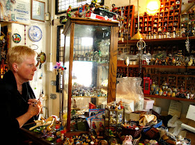 Browsing the miniatures for sale at The Old Tythe Barn dolls house shop at Blackheath