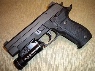 SIG Sauer P226 Elite Dark with attached Streamlight TLR-1s weapon light SIG Sauer P226 Elite Dark with attached Streamlight TLR-1s weapon light