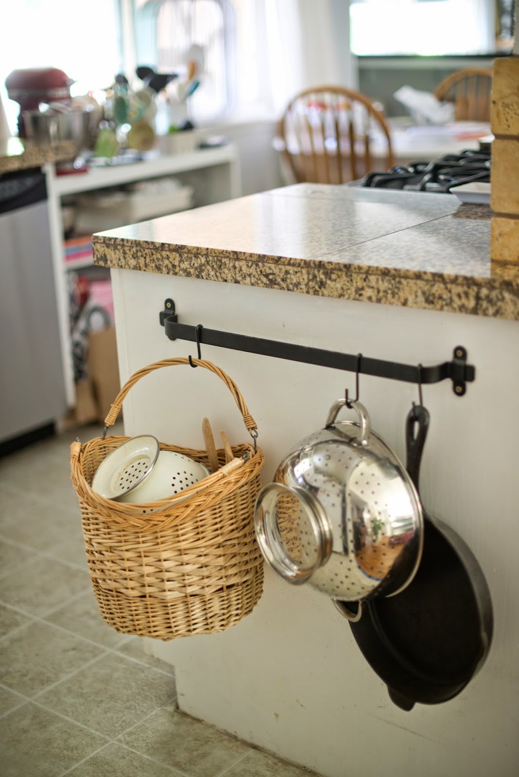 Use a towel bar to hold kitchen supplies. A cute way to organize the kitchen.