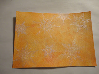 Orange salt background with snowflakes in white mica powder