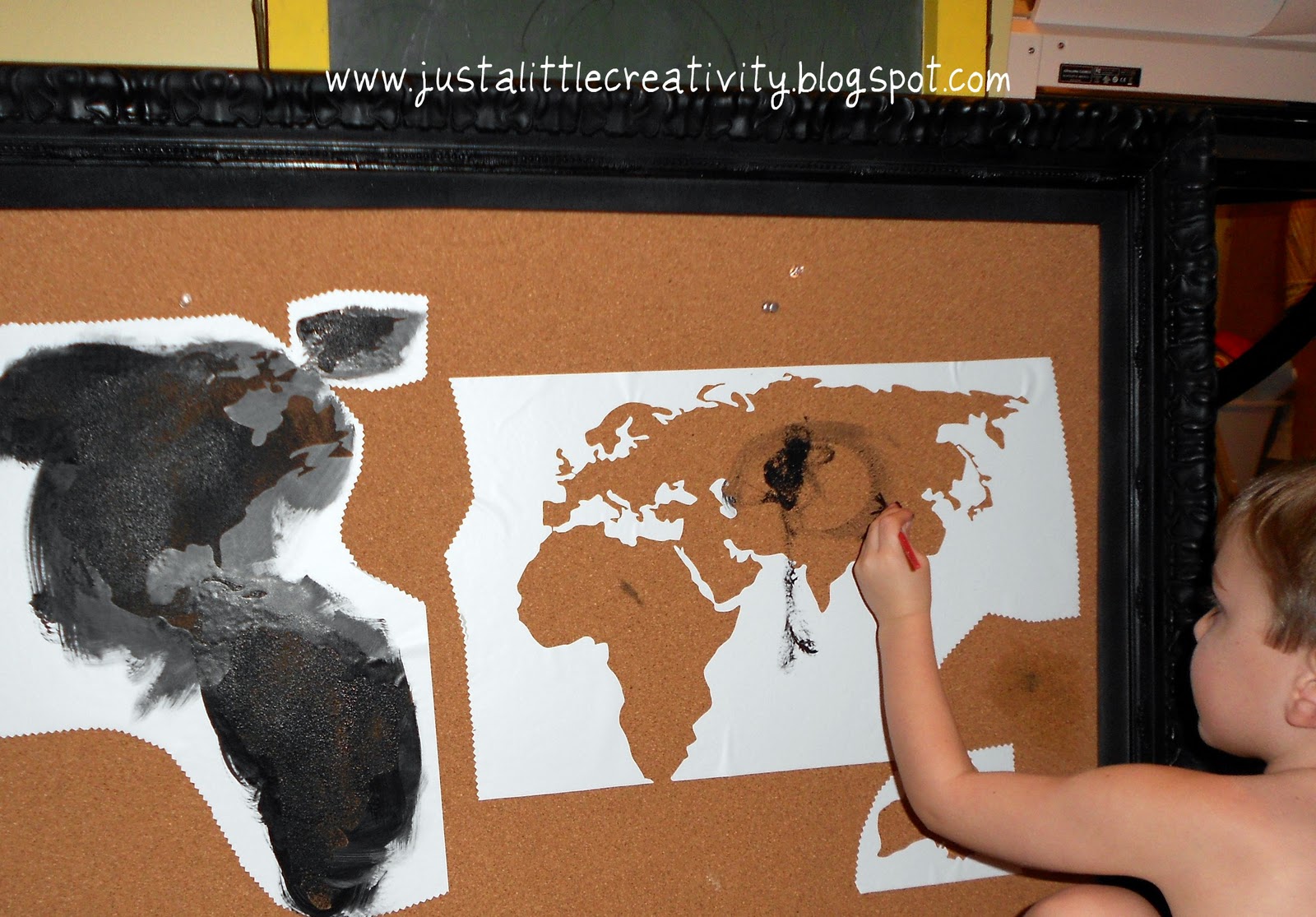 using my new silhouette cameo i cut a map of the world out of vinyl using the vinyl as a stencil i and my three year old helper painted in the