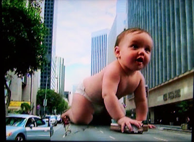 Photoshopped giant baby crawling down a city street