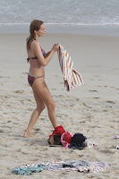 Heather Graham holding a towel at the beach