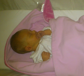 jaundiced premature baby asleep in blanket