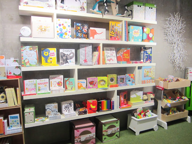 Floating shelves in Tottini's store holding children's books