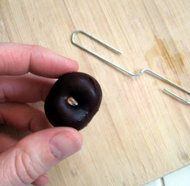 pitting a cherry with a paper clip