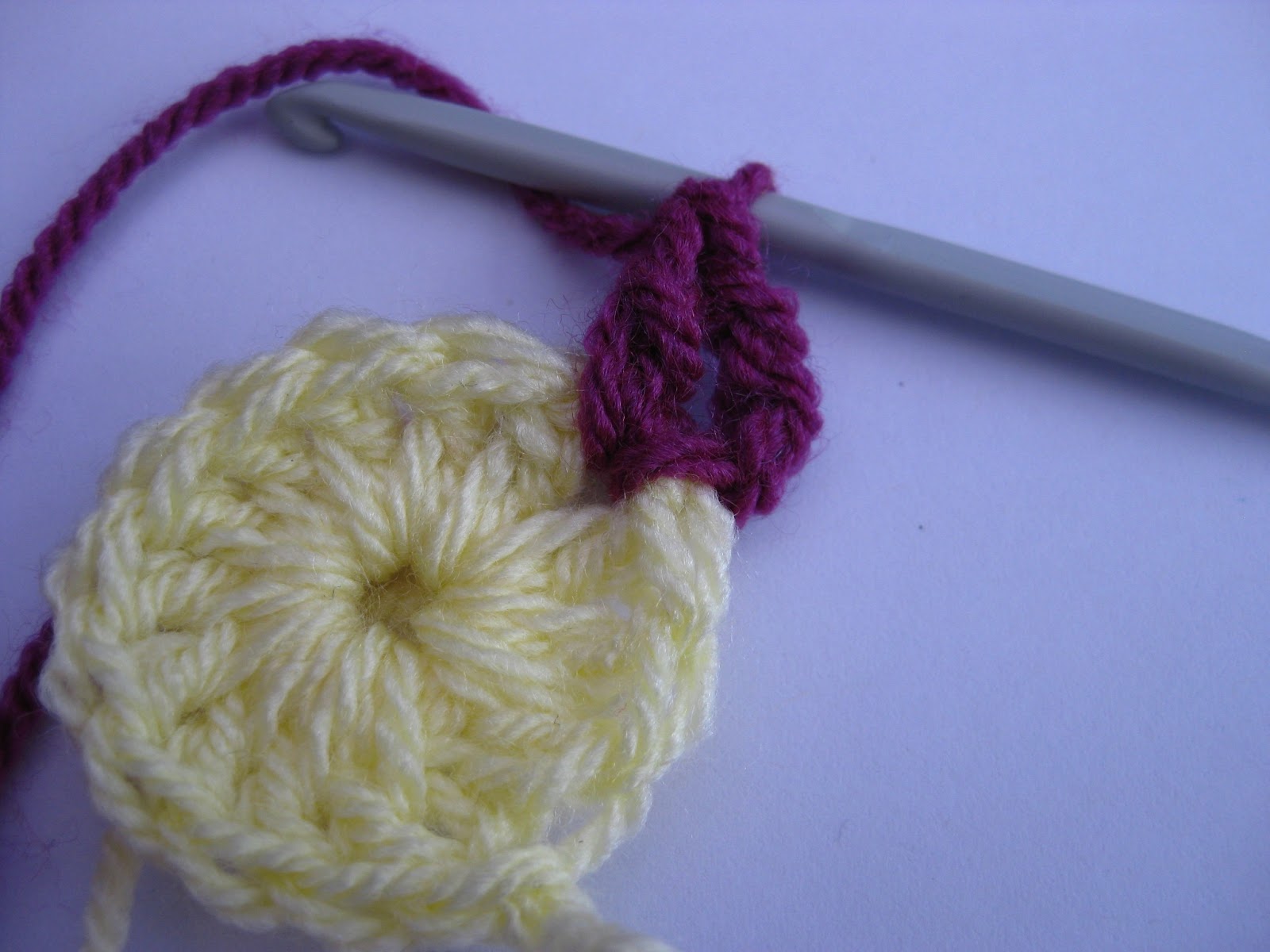 So , between the stitches of round 1slip stitch to join a new colour ...