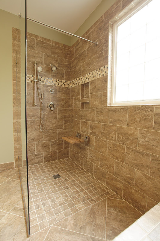 natural stone and glass accents and the teak bench seat in the shower title=