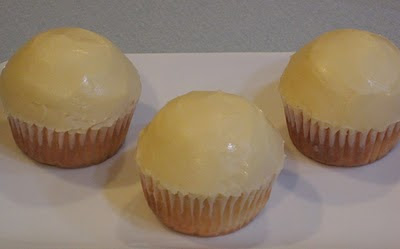 three cupcakes frosted with white icing