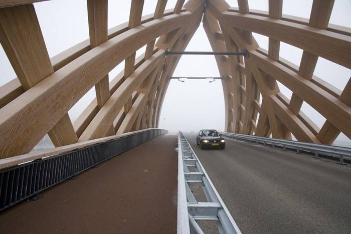 Wood Bridge In Netherland Commissioned by the Province of Friesland, Oak (Onix and Achterbosch Architecture) has developed a road bridge that connects 2 districts of Sneek on either side of the A7 motorway. The bridge was designed for a municipality that wished to establish a new city marker along the motorway. Framework The Department of Public Works, the user of the bridge, stated that it wished to use more wood in its constructions.