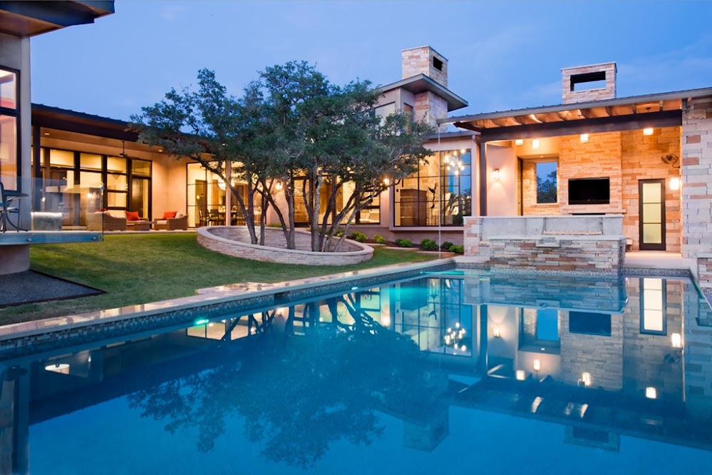 Photo of an amazing modern home as seen from the pool area