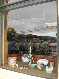 Cyclists reflected in window at the San Gregorio Store