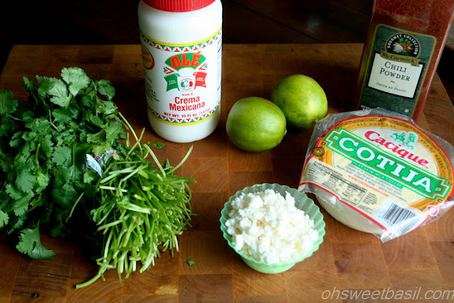 Mexican Street Corn, Elote, is one of the best things you can make on the grill, you have to try it! ohsweetbasil.com Mexican Street Corn - Elote Ingredients: Cilantro, Crema Mexicana, Two Limes, Cotija Cheese and Chili Powder.