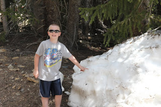 boy next to a mound of snow