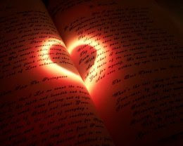 Love heart light shape shone on pages of open book