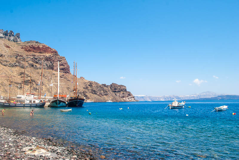 Boats, volcanic rocks and sea image of the boats and sea of islands near santorini
