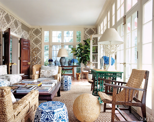sun room with french doors, woven chairs, blue and white chinese garden stools, and quadrille wallpaper
