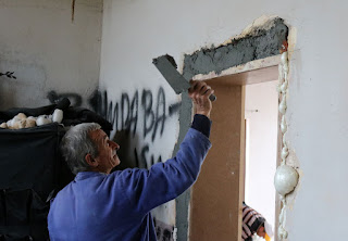 Slapping cement on around the door Slapping cement on around the door