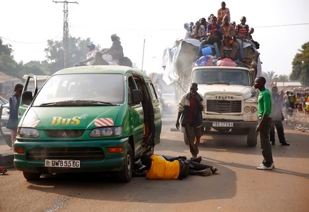 Central African Republic policemen chase looters attacking a broken-down truck as thousands of Muslim residents from Bangui and Mbaiki flee Bangui in a mass exodus using cars, pickups, trucks, lorries and motorcycles, escorted by Chadian troops Friday Feb. 7, 2014. Tit-for-tat violence killed more than 1,000 people in Bangui alone in a matter of days in December. An untold number have died in the weeks that followed, with most of the attacks in Bangui targeting Muslims. (Photo AP - thinkINpictures @1WORLD Community)